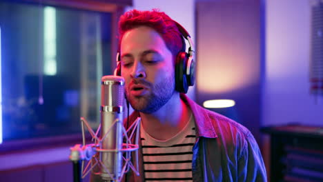 man recording music in studio