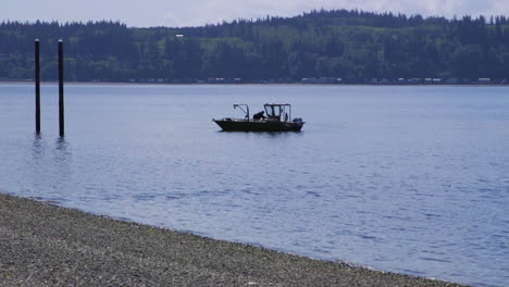 small, nondescript fishing floating near dock at camano island state park, wa state