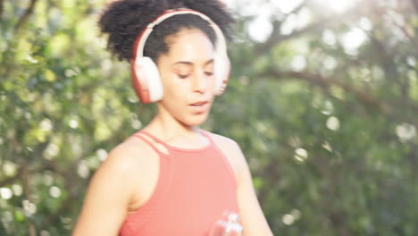 woman, fitness and drinking water in headphones