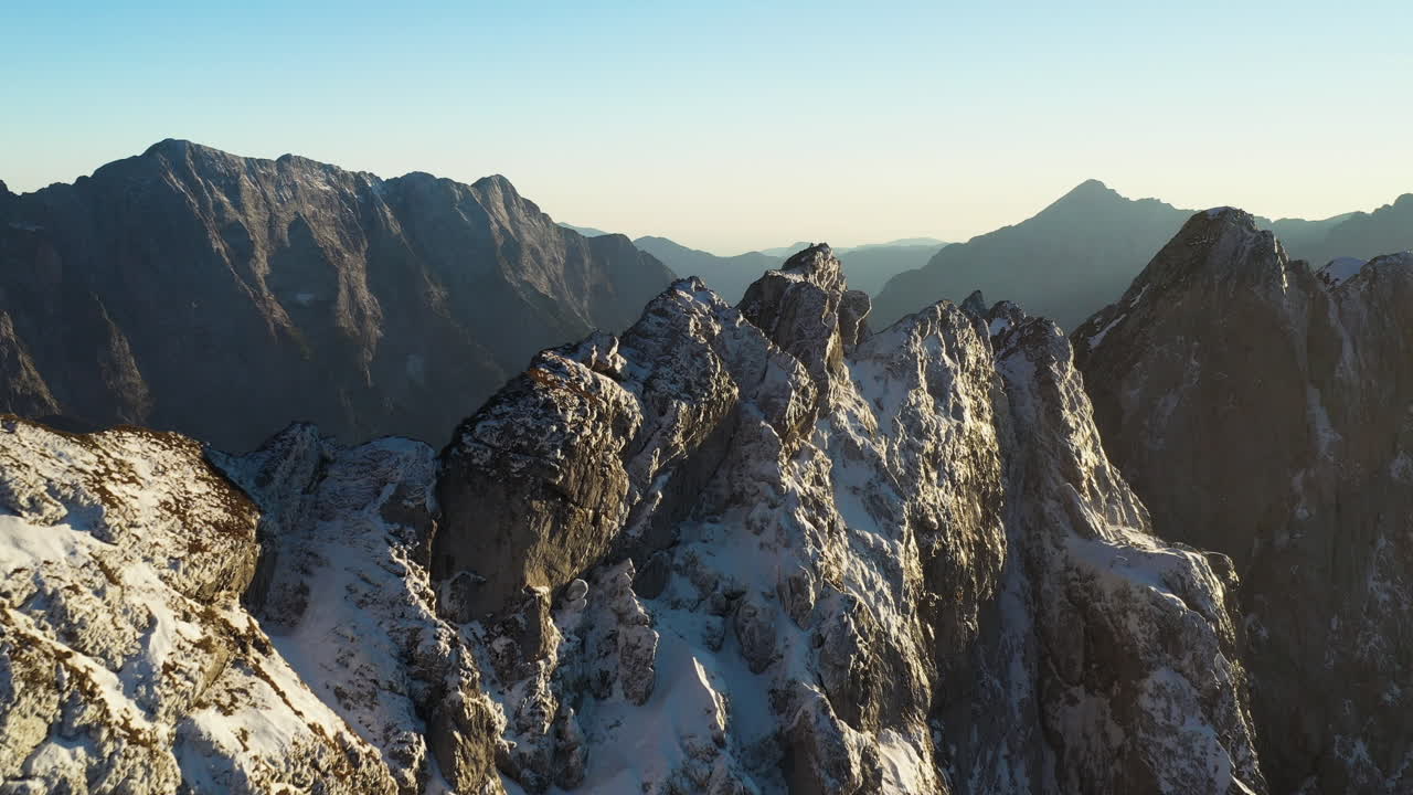 Cinematic drone shot of the snow covered Mangart mountain in the Julian Alps in Slovenia