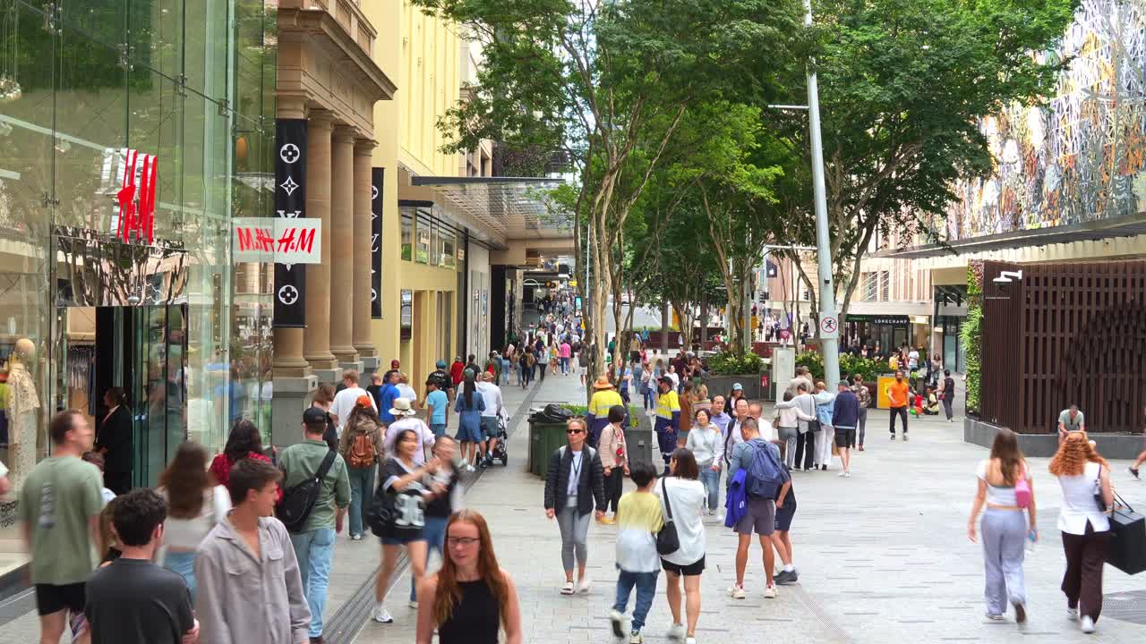 Urban environment, street scene of downtown Brisbane city, shoppers shopping at Queen street mall on the weekend, people strolling at outdoor pedestrian shopping precinct, fast motion time-lapse shot.