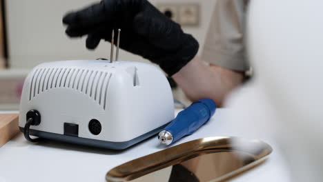 nail technician working with tools