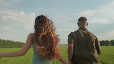 back view of adult jogging through vast green field, long hair swaying in gentle breeze with each powerful stride, muscles flexing and feet crunching grass under clear sky