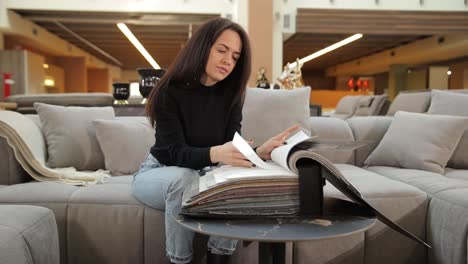 woman looking at a catalog of furniture samples
