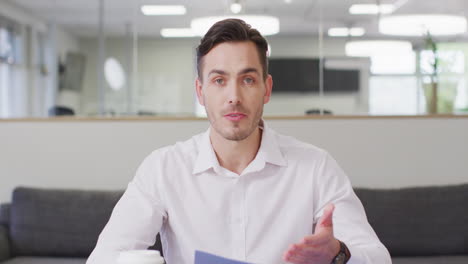 Caucasian-businessman-having-video-call-at-office,-slow-motion