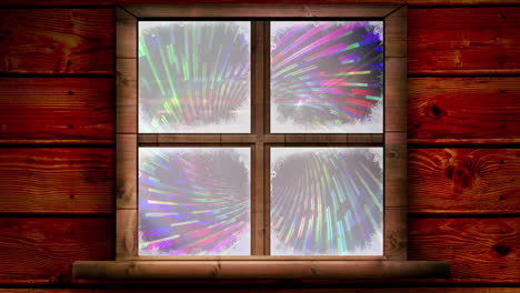 wooden window frame against colorful light trails spinning on black background