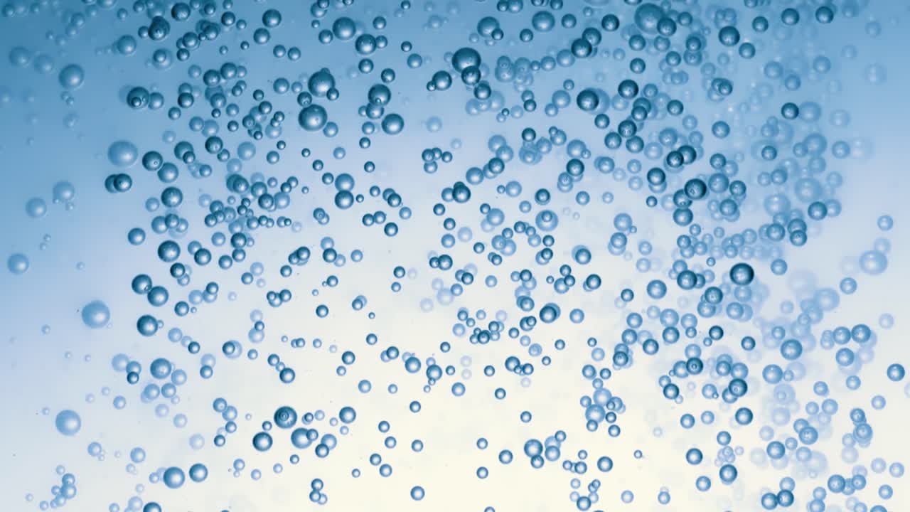 Many water bubbles in blue water close up, abstract water wave with bubbles in slow motion.