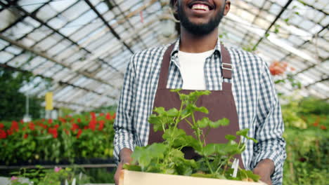 happy gardener in greenhouse with plants