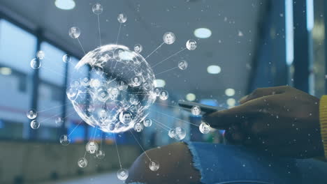 animation of globe and social media users over hands of biracial woman using smartphone