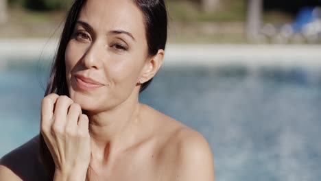 Attractive-young-brunette-at-the-swimming-pool