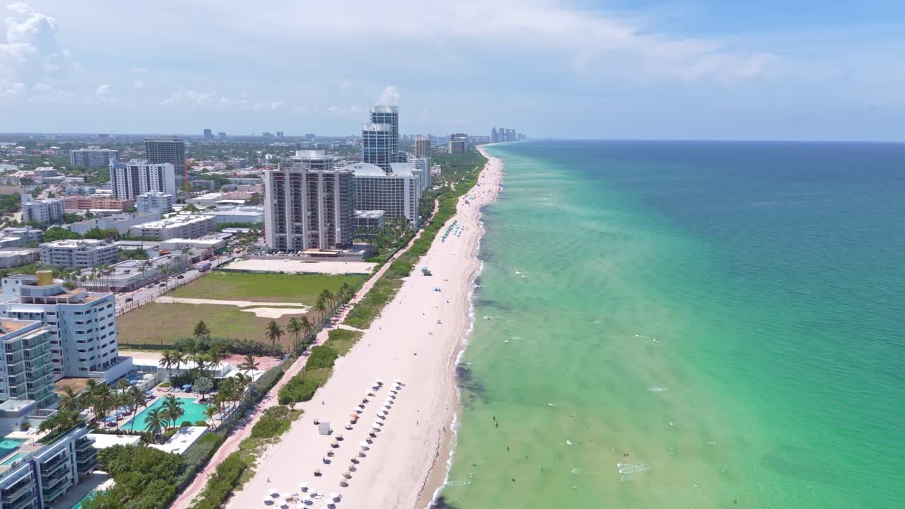 Luxury hotels with swimming pool and private beach access in Miami Beach, Florida. Aerial Birds Eye shot. Sunny day in America