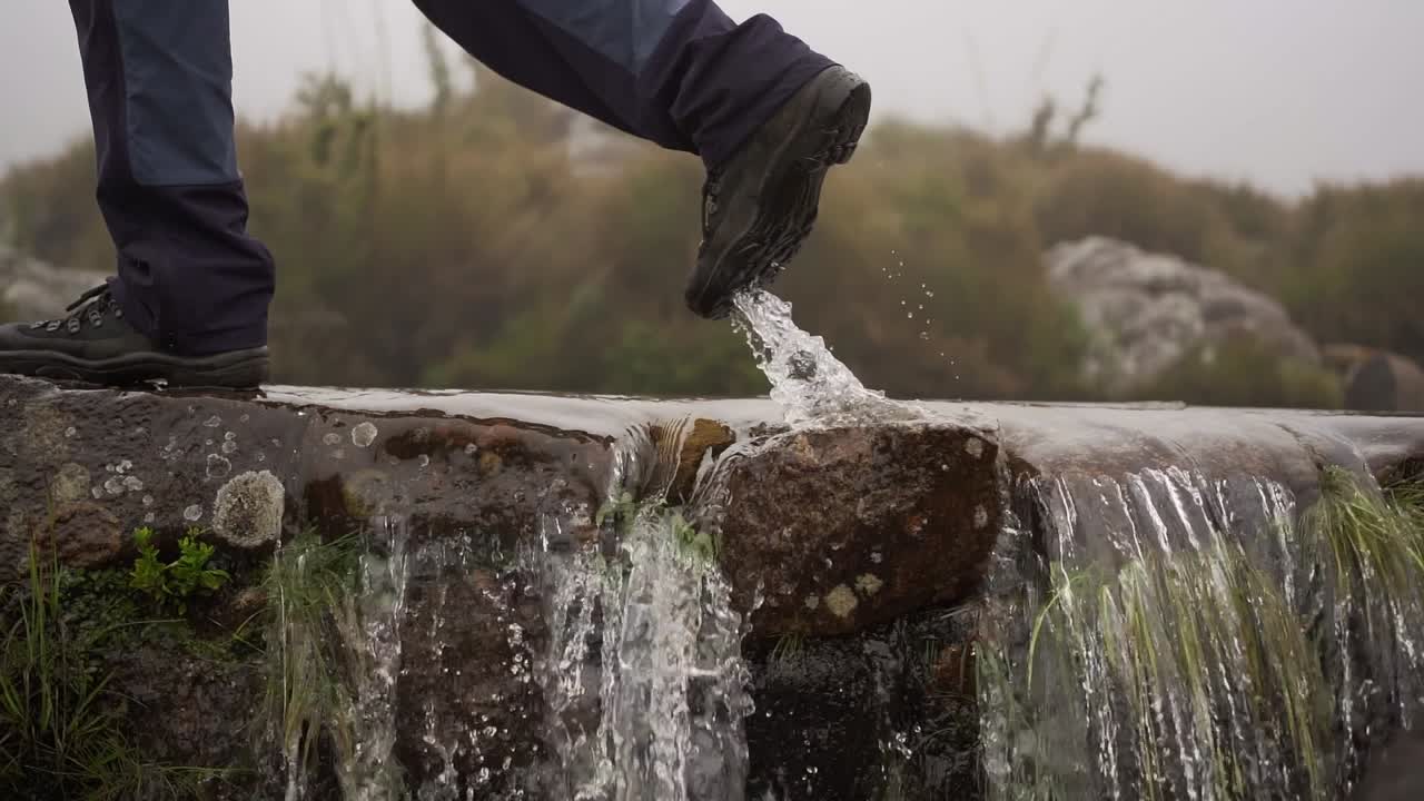 Stepping over a waterfall in Itatiaia, Minas Gerais, Brazil, in nature