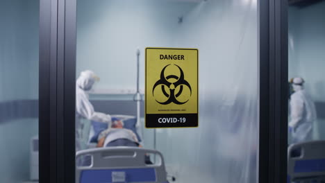 covid-19 hospital isolation ward with patients and medical staff