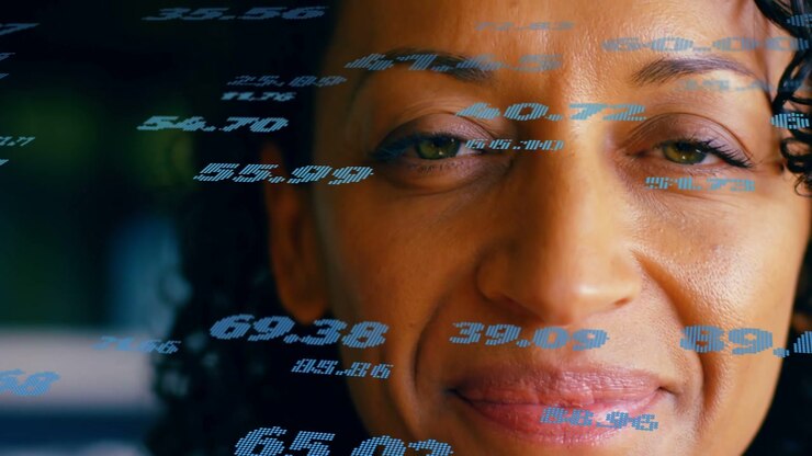 Mature woman viewing incoming holographic numbers across face, reacting and analyzing tech metrics