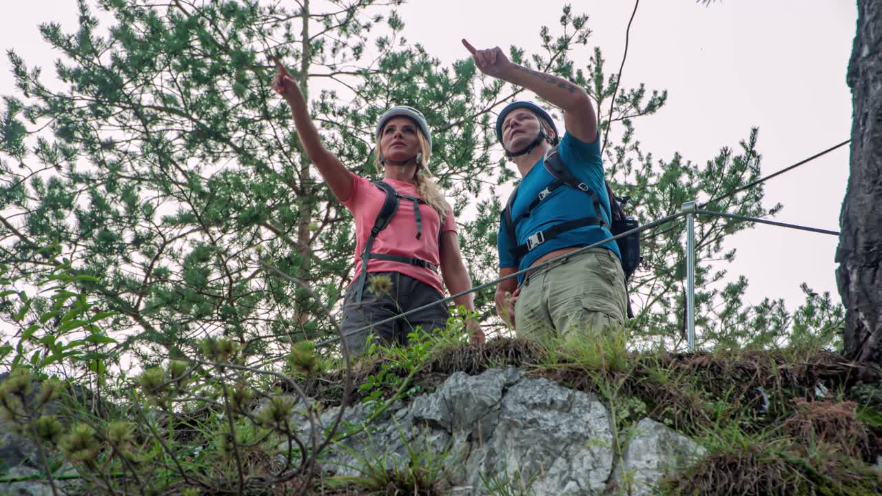 Man and woman looking where to go next. Outdoor hiking activity. Slovenia