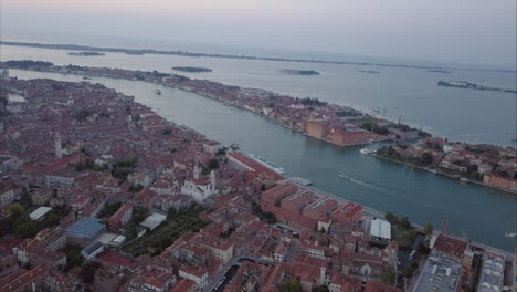 wide aerial shot of moving towards giudecca from above at dusk, venice, italy