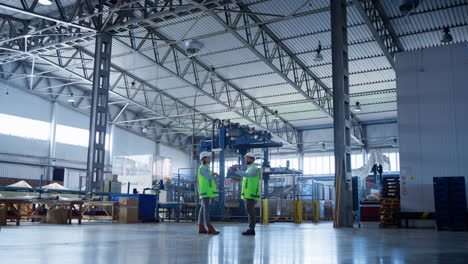 Factory-storage-employees-talking-about-storehouse-delivery-boxes-inspecting