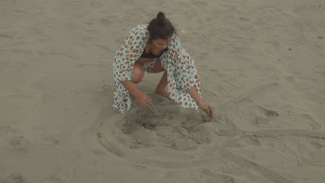 An-Indian-woman-immerses-herself-in-the-joy-of-playful-moments-at-the-beach