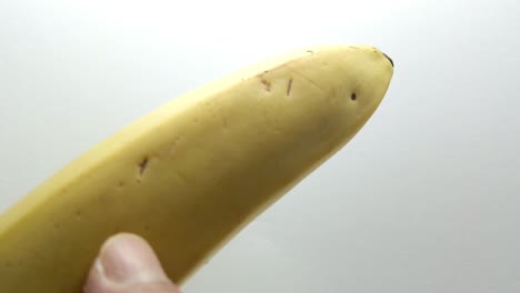 point finger gently touches a banana fruit