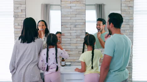 Parents,-kids-and-brushing-teeth-in-bathroom