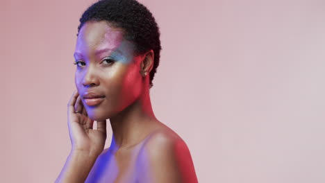 african american woman with short dark hair in blue and pink light with copy space, slow motion