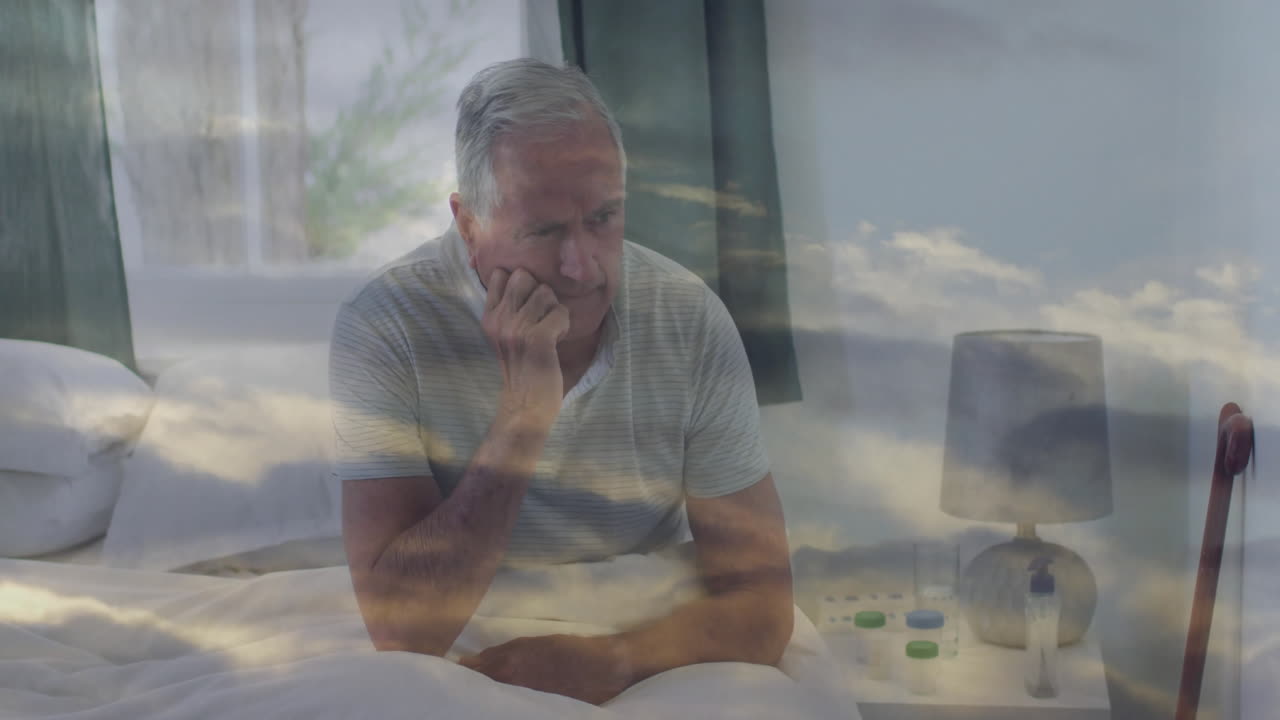 Elderly man sitting on bed with thoughtful expression over cloud animation