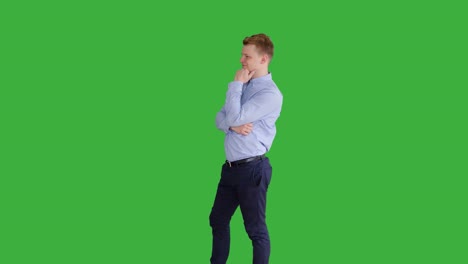 young handsome men acting in front of a green screen. blond hair, blue shirt and blue trousers. dancing, thinking, turning around and talking to the camera.