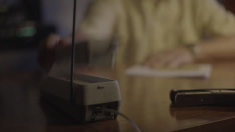 man writing at a desk at night