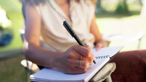 person, hands and notebook for writing