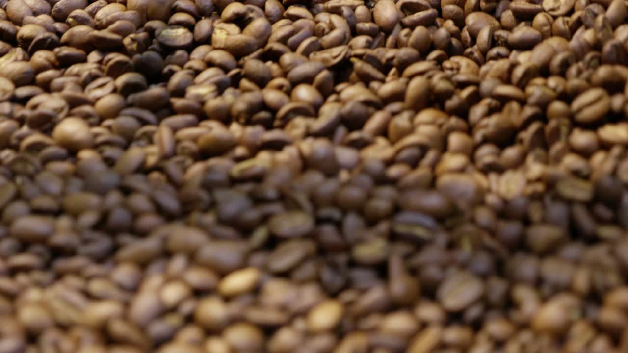 Explore the intricate details of coffee roasting showcasing rich textures and earthy tones.