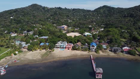 waterfront beach and buildings at camp bay, roatan in caribbean sea