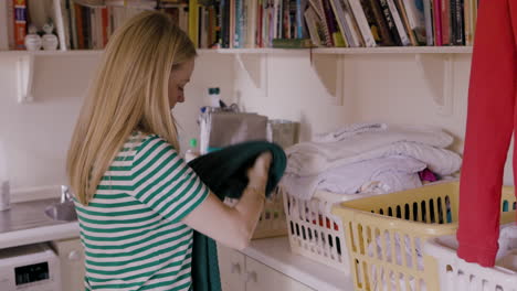 woman folding laundry indoors
