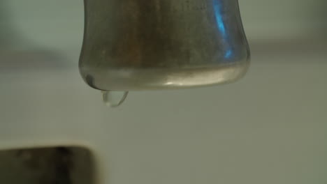 closeup of a faucet as water drips out