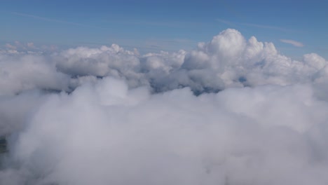 beautiful cloudy view of the descent into kelowna, bc from the isle seat of a plane