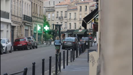 a european city street with cars and pedestrians