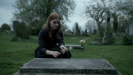 woman mourning at a grave