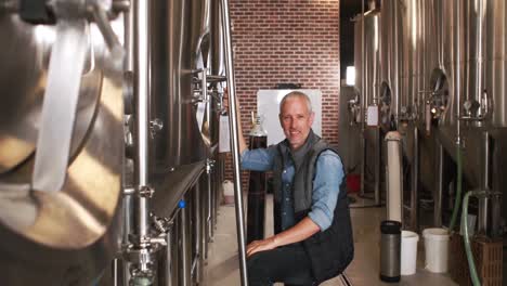 brewery worker getting down of a ladder