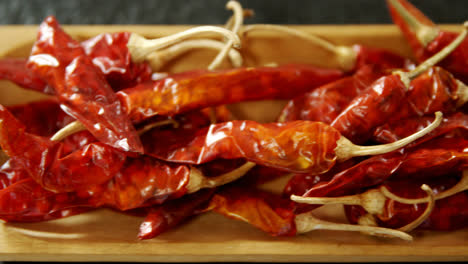 dried chili pepper in wooden tray 4k