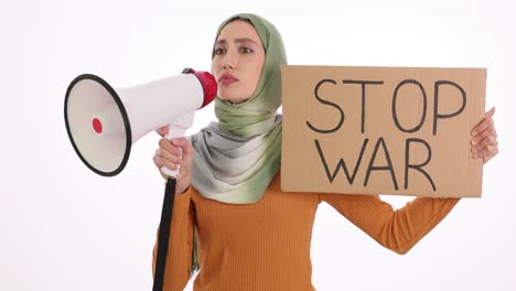 woman in hijab protesting war with megaphone and 'stop war' sign