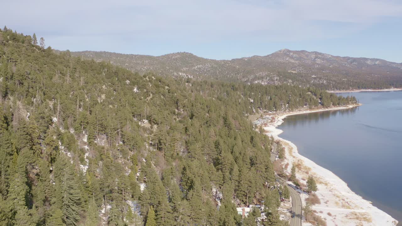 over bigbear lake frozen with ice trees and snow