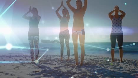 animation of glowing communication network over female friends doing yoga on sunny beach