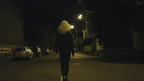 alone girl walking street in urban wear at late night in city centre.