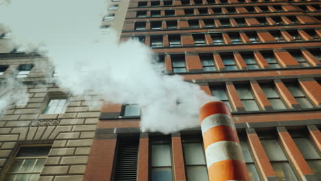 pipe with excess steam from the steam system of new york bright orange striped - one of the symbols