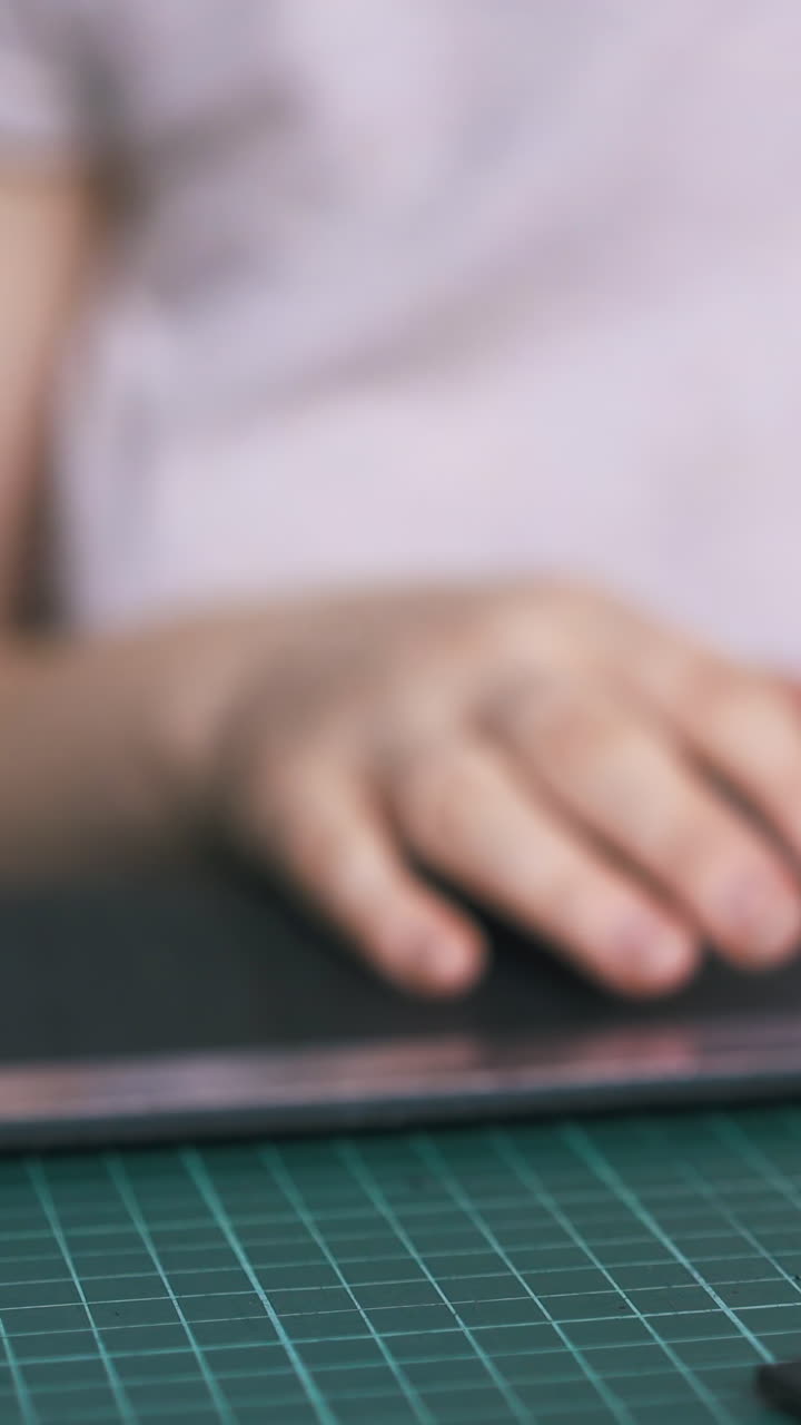 CU: Careful woman closes leather paint bottle and takes pure copper on green cushion board close view