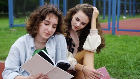 students sitting on running track