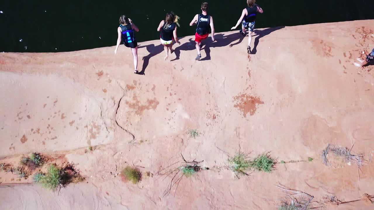 Top down drone shot of group of cliff jumpers in Lake Powell Utah