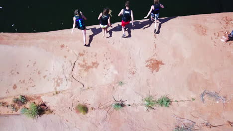 top down drone shot of group of cliff jumpers in lake powell utah