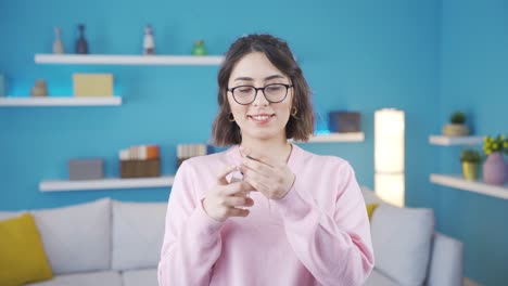 Beautiful-young-woman-sprays-perfume-and-is-happy.