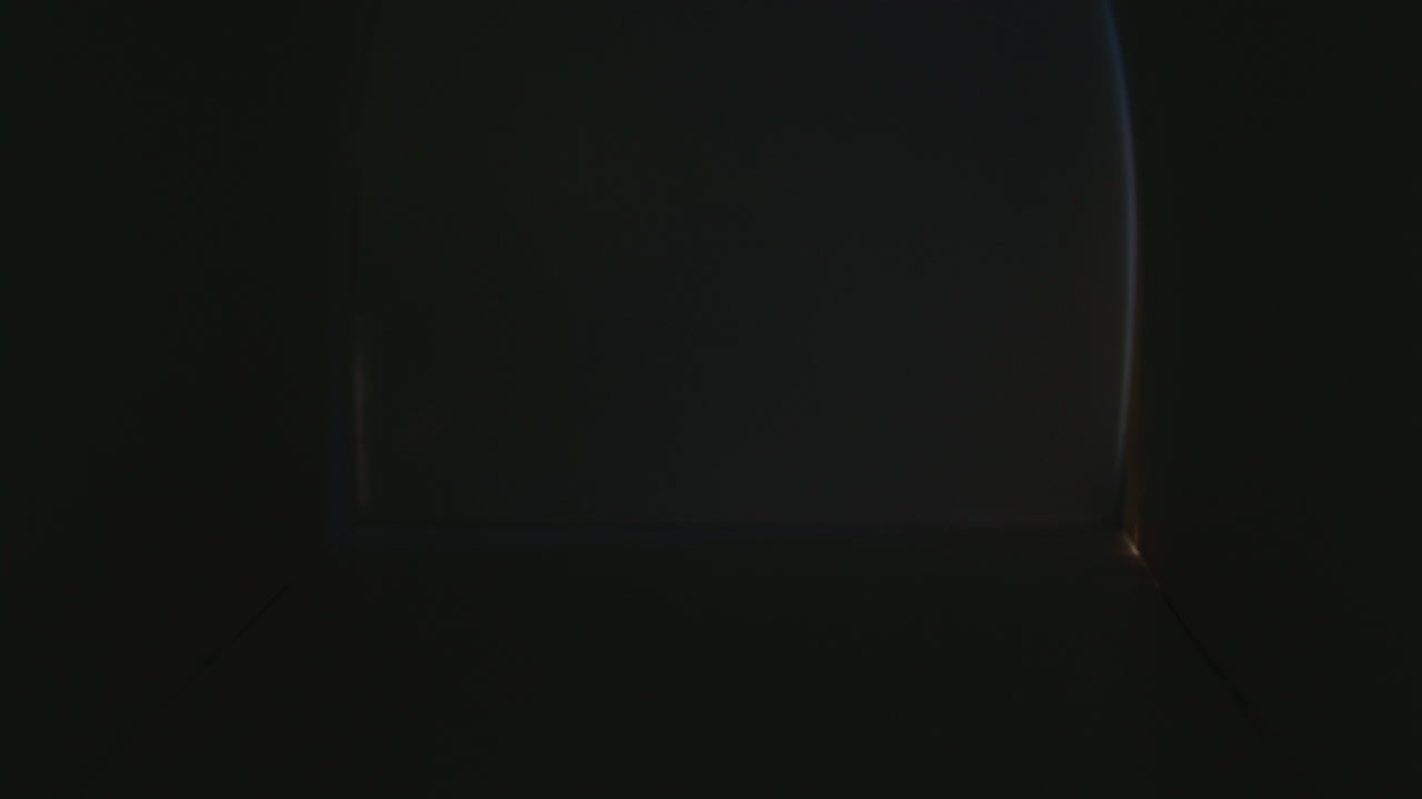 Female Postal Worker Delivering Envelopes and Parcel into Mailbox