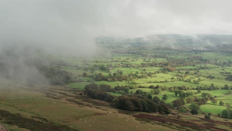 British-rural-landscape,-green-fields,-low-clouds-with-partial-sun